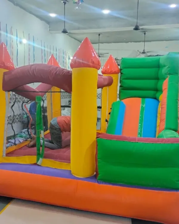 A look inside my workshop where a classic bouncy castle is being inflated for a quality check. This one has a slide and a jumping area.