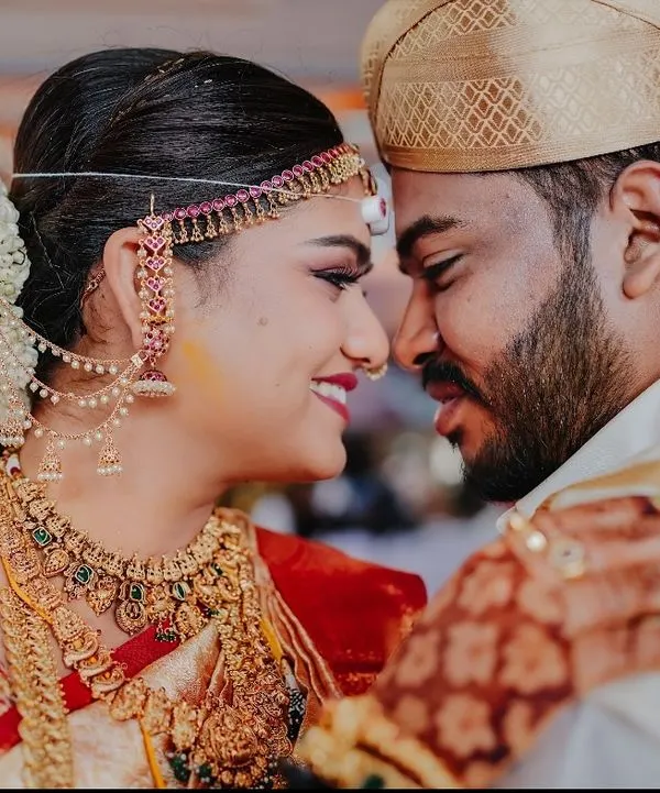 An intimate close-up of a newly married couple. This photo focuses on their emotional connection, capturing the quiet moment of love and respect between them.