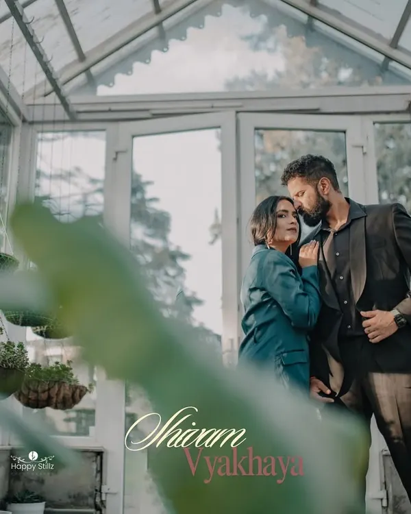 A romantic embrace inside a beautiful glasshouse in Mussoorie. The soft light and lush greenery create a dreamy, intimate setting for a destination pre-wedding photoshoot.