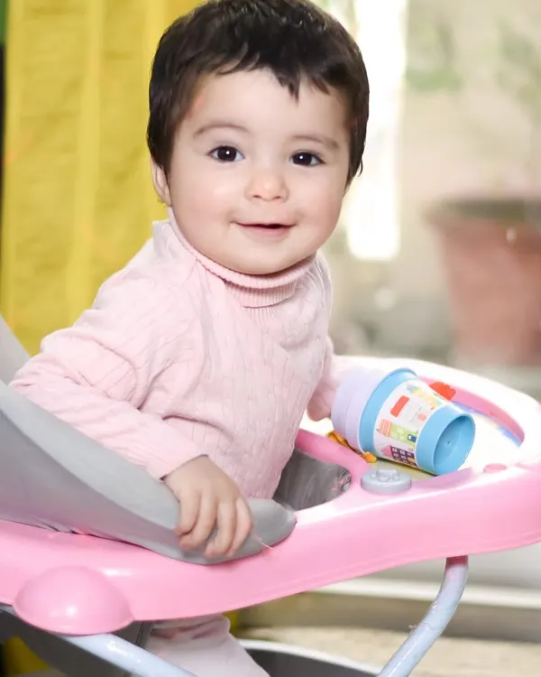 A happy smile from her baby walker. At-home lifestyle sessions are all about capturing your child's daily life and genuine expressions in their own environment.