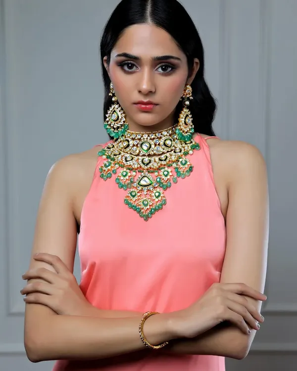 In this jewellery campaign, I styled a magnificent emerald and polki bib necklace with a simple pink halter top. This allows the intricate, multi-layered design of the traditional Indian jewellery to be the undisputed star of the shot.