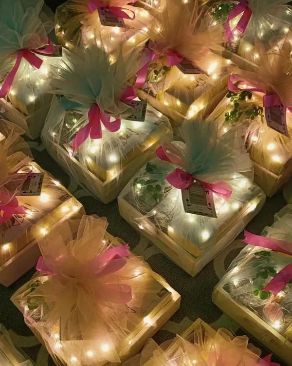 Light up your Diwali with our magical gift hampers. These pinewood trays are filled with goodies and wrapped in tulle with fairy lights, creating a truly dazzling effect when illuminated.