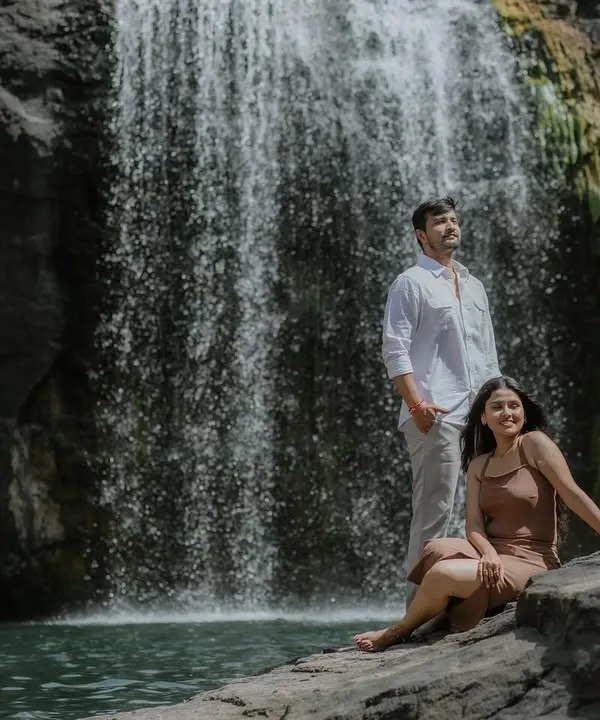 A beautiful couple portrait set against a cascading waterfall. The natural setting provides a powerful and serene backdrop for this pre-wedding shoot.