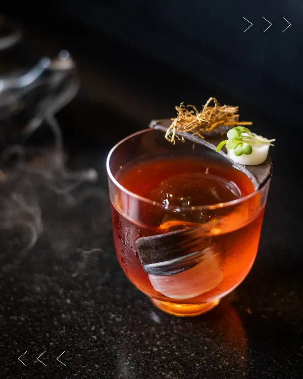 This is our Kozhikode Negroni, a bold and coastal twist on a classic. It features Bombay Sapphire, nibs-infused Martini Rosso, and a bitter aperitif, all brought together with a final vetiver spray for an unforgettable aroma.