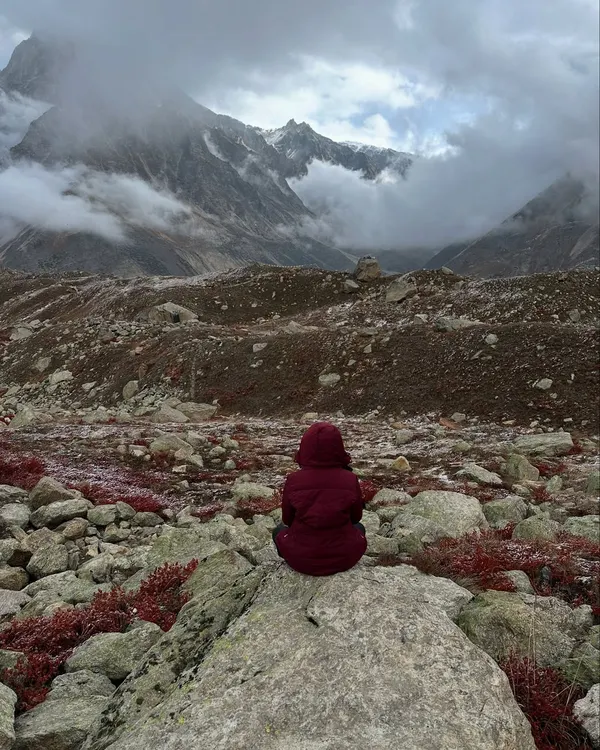 Sitting in stillness amidst the raw, majestic landscape of the Himalayas during our Tapovan trek. In moments like these, you realize the mountains, the sky, and the silence are all reflections of what is already within you.