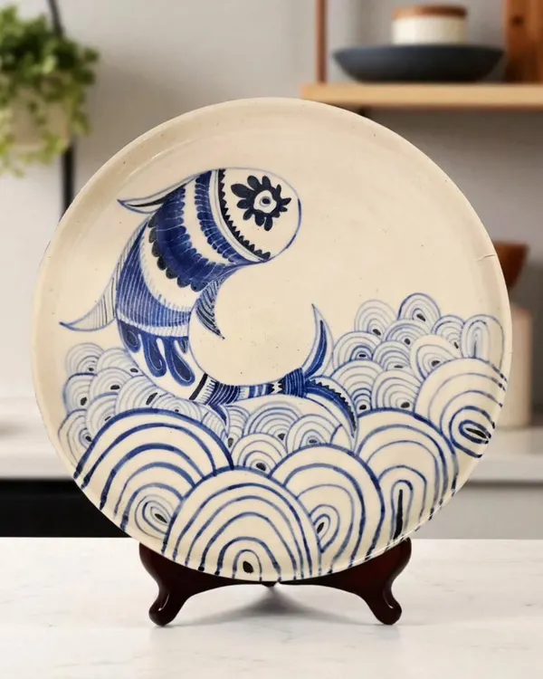 This hand-thrown ceramic plate, featuring a hand-painted fish motif, captures the essence of my work. It is designed to be a versatile piece of art, perfect for adorning your walls or bringing a touch of elegance to your dining table.