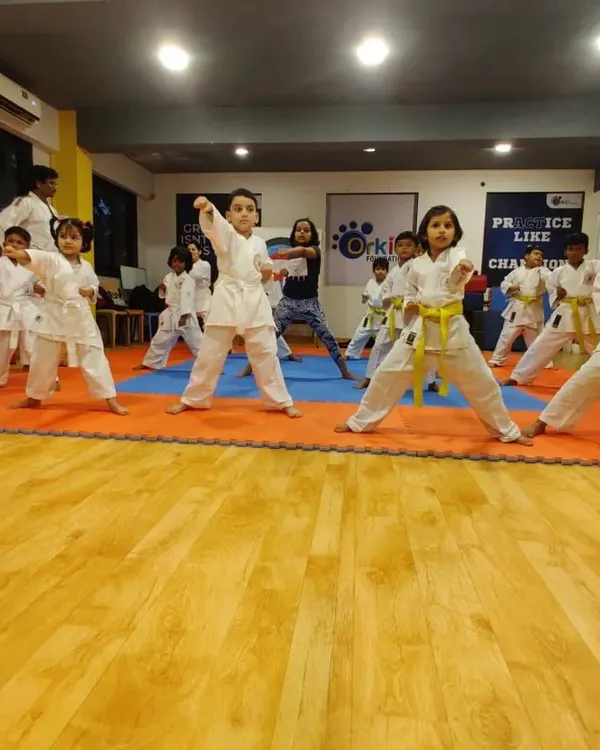The journey of a thousand miles begins with a single step. Here, our youngest karateka practice their foundational stances and kata forms in a group class, building discipline, focus, and strength from an early age.