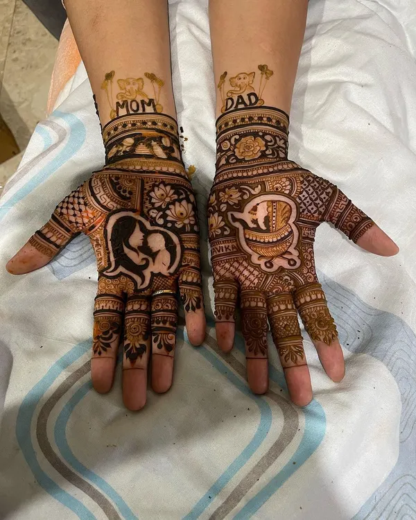 A heartwarming baby shower design. One hand features a silhouette of a mother and child, while the other has a baby in a cradle. The wrists are personalized with "Mom" and "Dad".