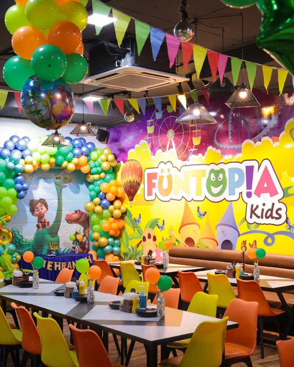 Our cafe area fully transformed for a dinosaur-themed party. The colorful chairs, themed decorations, and spacious seating create a vibrant and comfortable atmosphere for guests.