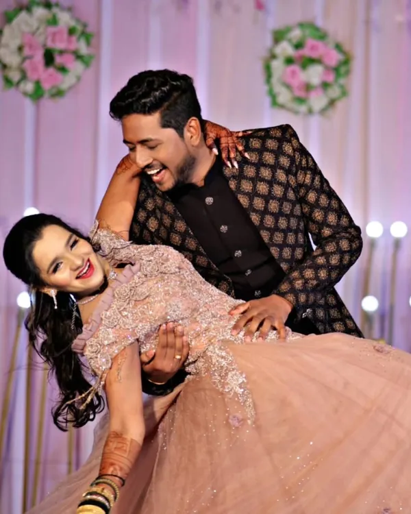 This is what pure joy looks like. We love helping couples find the perfect outfits that make them feel amazing on their special day, like this stunning peach gown and printed Jodhpuri suit combination, perfect for a sangeet or reception dance.