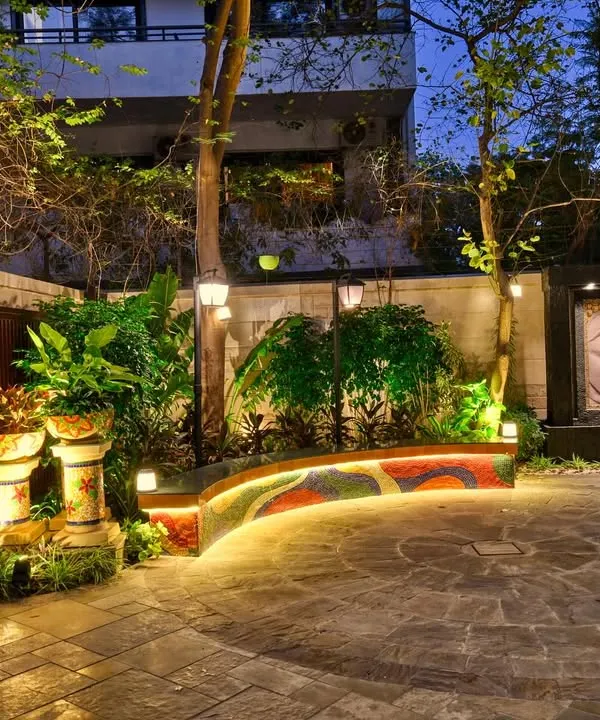 We transform simple backyards into serene sanctuaries. This space was designed for quiet evenings and peaceful moments, featuring a custom mosaic bench, a calming Buddha water feature, and strategic lighting that creates a magical ambiance after sunset.