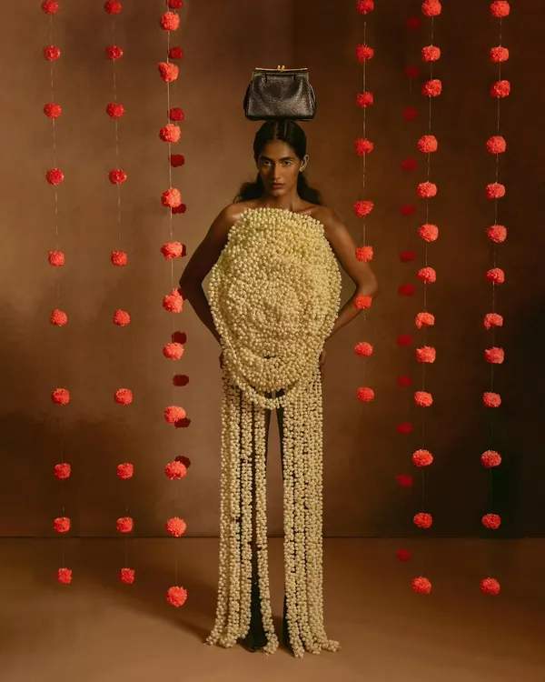 This image is from a conceptual shoot where we explored the fusion of natural elements with avant-garde fashion. We created this entire garment from fresh jasmine and marigold flowers to tell a story of ephemeral beauty, blending traditional Indian florals with a high-fashion silhouette.