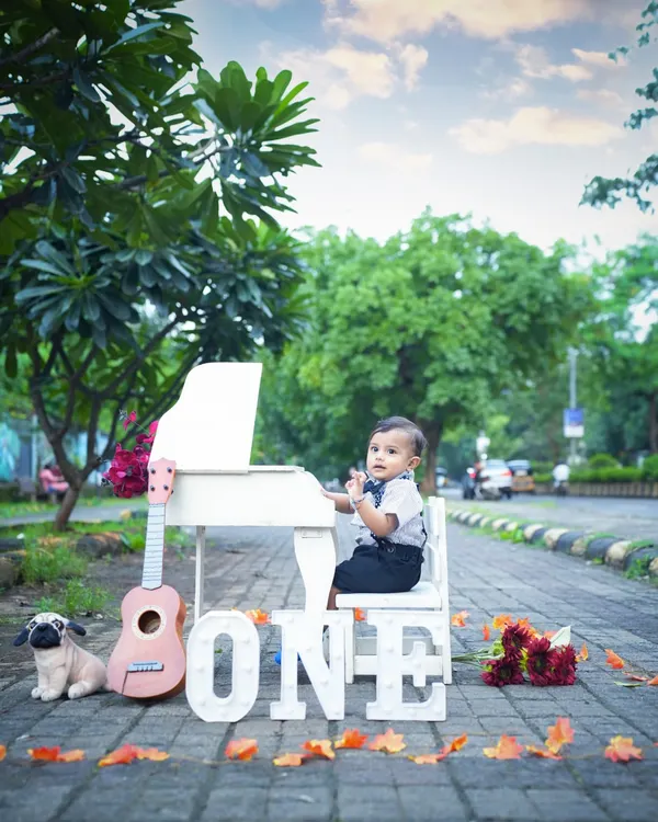 Celebrating the big ONE! This little boy looks so dapper with his miniature piano and guitar. An outdoor milestone shoot is a wonderful way to mark a first birthday.