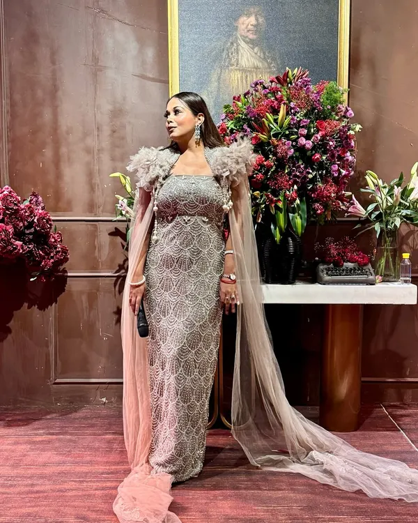 Dressed for a glamorous evening of hosting. This sparkling gown with a dramatic cape is perfect for making a statement at a cocktail or reception night.