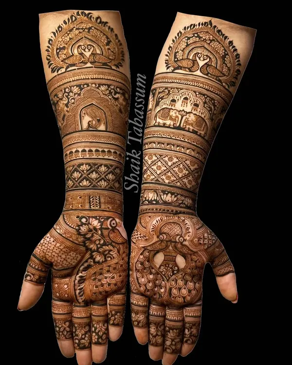 A masterpiece of traditional motifs, this design is filled with graceful peacocks and royal elephants. The intricate patterns and shading showcase the depth and beauty of classic henna art.