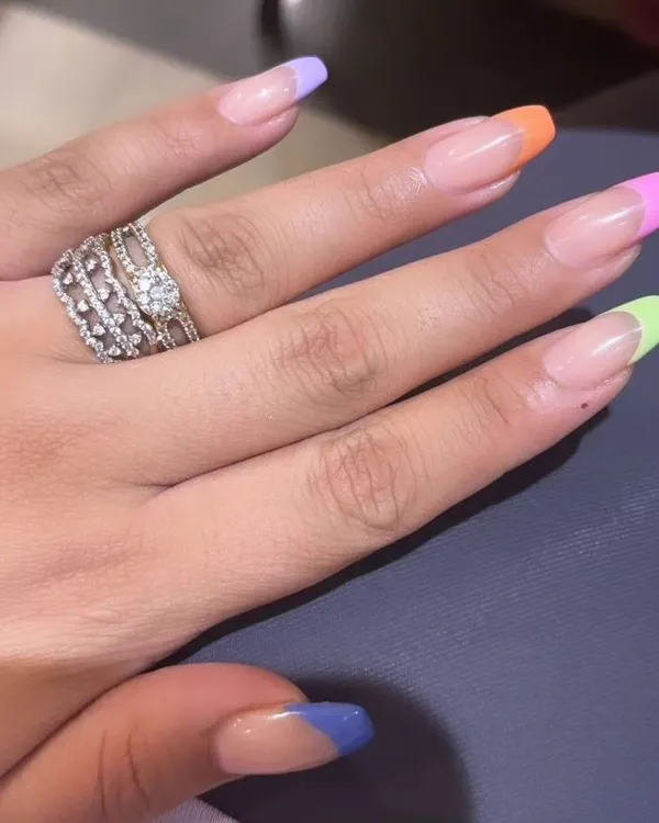 A playful and colorful take on the French manicure with a different pastel shade on each nail tip, perfect for a fun, summery look.