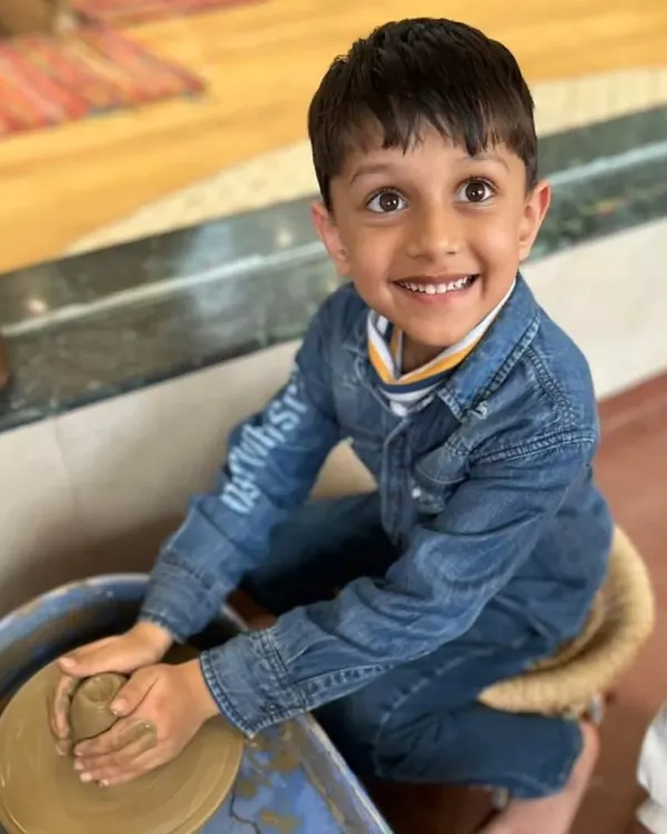 This is the kind of pure joy I love to see. Here, a young artist discovers the magic of the pottery wheel for the first time, feeling the clay take shape under his hands. It's a wonderful sensory experience that builds focus and confidence.