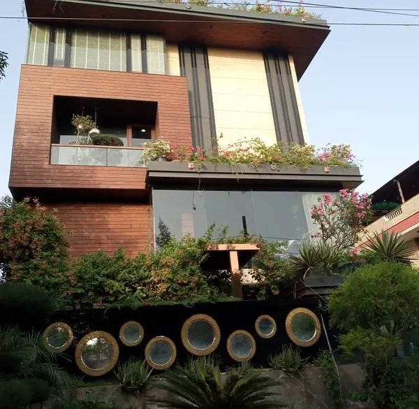 A full view of a modern villa in Noida where I designed and installed integrated greenery on the ground floor, balconies, and a full rooftop garden.