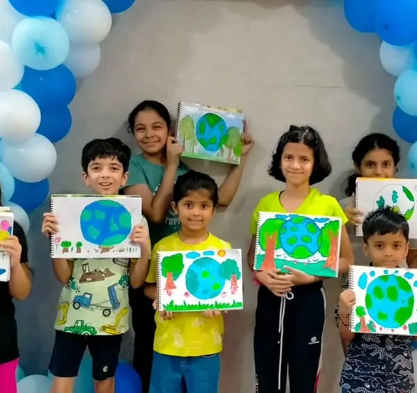A group of proud young artists showing off the Earth paintings they created during a workshop. Our art activities are a great way to add a creative touch to any party.