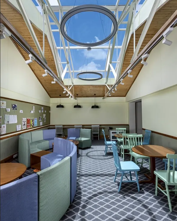 This light-filled student lounge at Woodstock School, transformed from a previously underused space, embodies my approach. By introducing a large skylight and using a student-centric design, we created a vibrant, modern hub for learning and interaction within a 165-year-old heritage building.