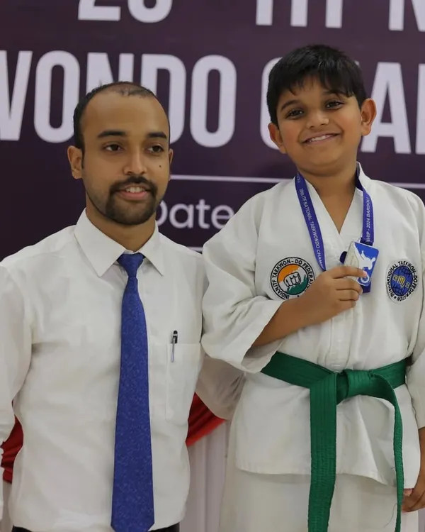 Posing with a young student and his new medal at the ITF National Taekwon-Do Championship. Seeing my students succeed is the greatest reward.
