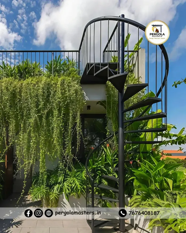 A sleek black spiral staircase provides access to a rooftop garden, surrounded by lush greenery. Its compact footprint preserves valuable space while adding a modern, sculptural element to the verdant setting.