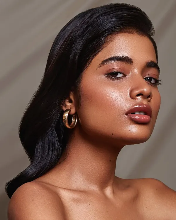 A soft, luminous beauty portrait with a focus on glowing skin and natural makeup. This shot highlights my ability to use subtle lighting to sculpt features and create a flawless, dewy look.