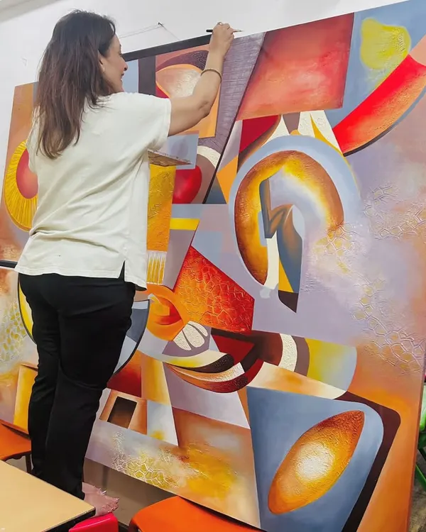 Creating a large commissioned piece is a labor of love and intense focus. Here I am, standing on a stool to reach the top of the 5.5 by 7 feet "The Sounds of Music" canvas, ensuring every part of the composition is perfect.