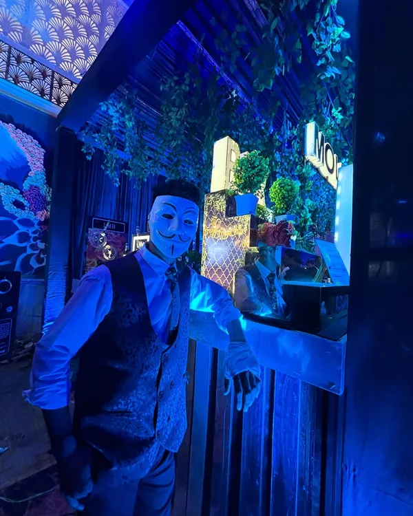A member of our team in a themed mask, ready to create a unique and mysterious bar experience for your guests.