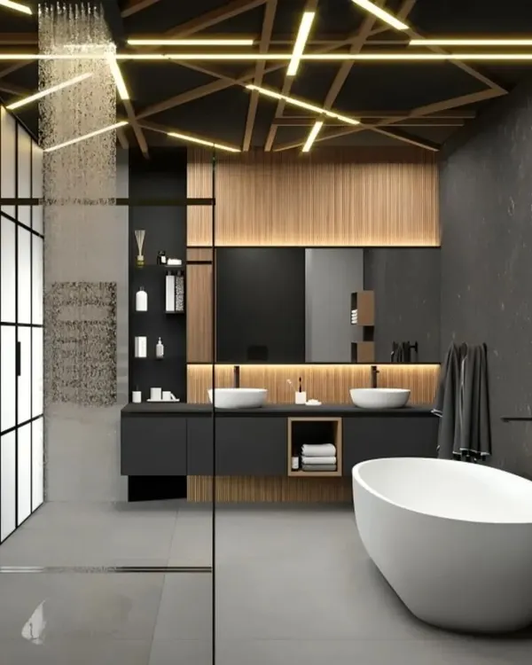 We designed this master bathroom as a luxurious private retreat. It features a freestanding bathtub, a spacious walk-in shower with a rainfall head, and dramatic ceiling lighting that creates a unique, high-end ambiance. The dark stone tiles and warm wood accents complete this modern, spa-like experience.
