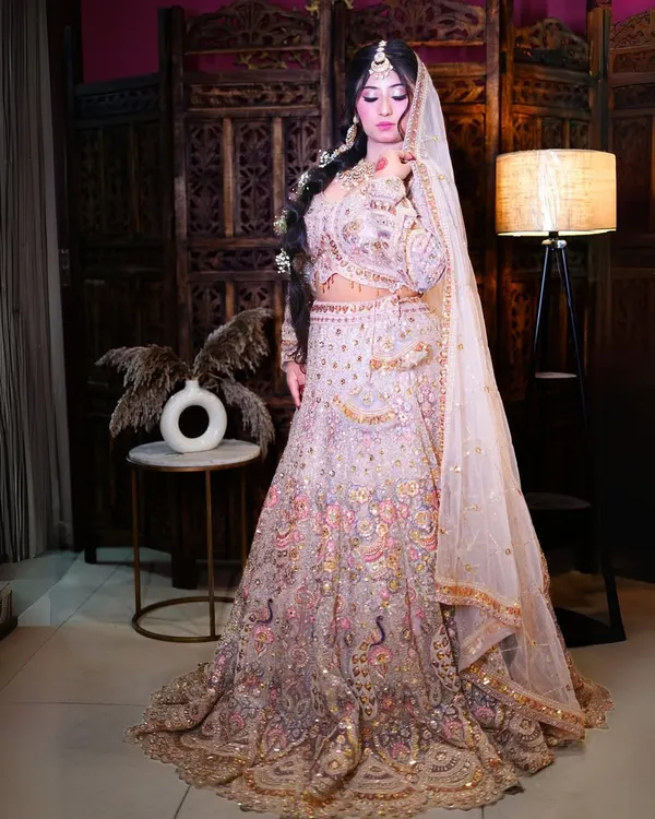 This is the ultimate bridal lehenga for your big day. The intricate multi-color peacock embroidery and heavy stonework create a truly royal look, ensuring you are the star of your wedding.