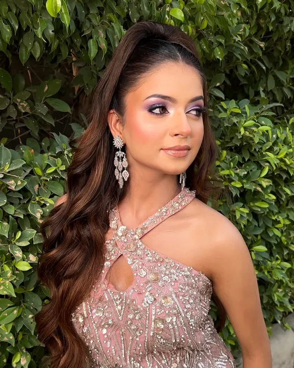Just the right amount of glam for a once-in-a-lifetime moment. This engagement look features a stunning purple smokey eye and a high ponytail, creating a chic and modern vibe.
