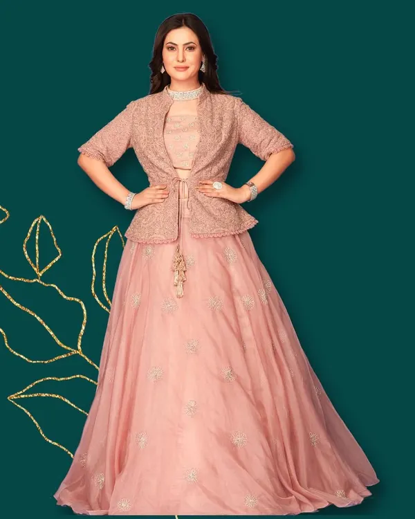 What's trending? This beautiful indo-western attire. A blush pink lehenga paired with a matching embroidered peplum jacket for a chic, modern look.