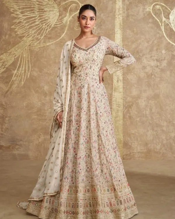 This floor-length Anarkali is the epitome of understated luxury. The full-flair design is covered in delicate, multi-colored floral embroidery, making it a work of art.