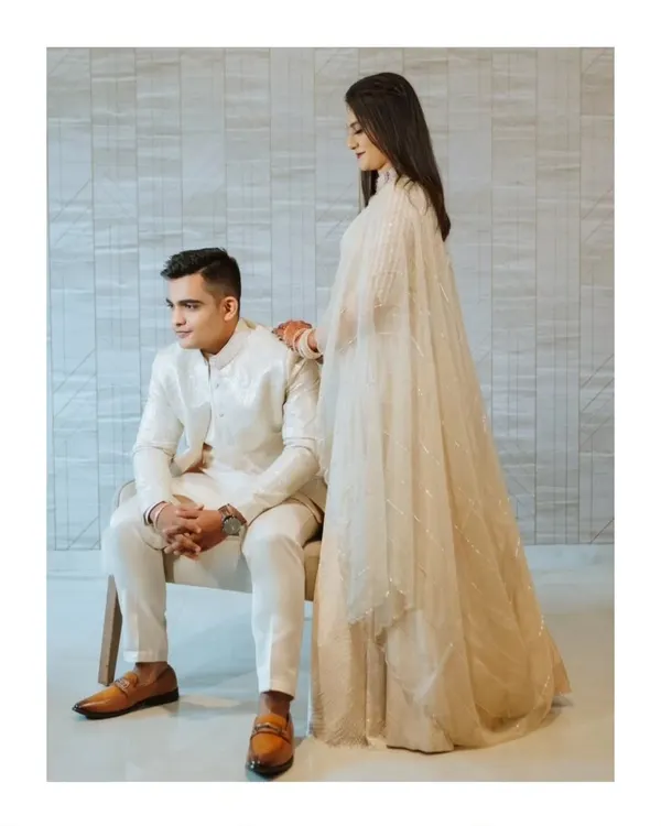 An elegant, minimalist portrait of the couple in coordinated all-white outfits. This clean and modern style creates a timeless and sophisticated look for engagement photos.