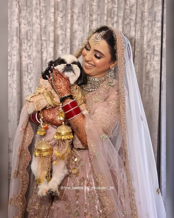 A bride and her best friend. It was so special to see her enjoying her wedding day with her furry companion, her beautiful henna stain adding to her bridal glow.