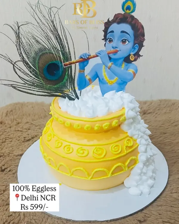 A divine centerpiece for your Janmashtami celebration. This cake features a beautiful figurine of Lord Krishna playing his flute, emerging from a pot of butter, and is adorned with a real peacock feather.