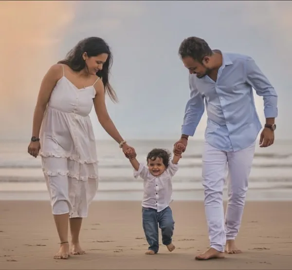 Hand in hand, taking their first steps as a family on the wet sand. This image captures the story of guidance and love as parents lead their little one on a seaside adventure.