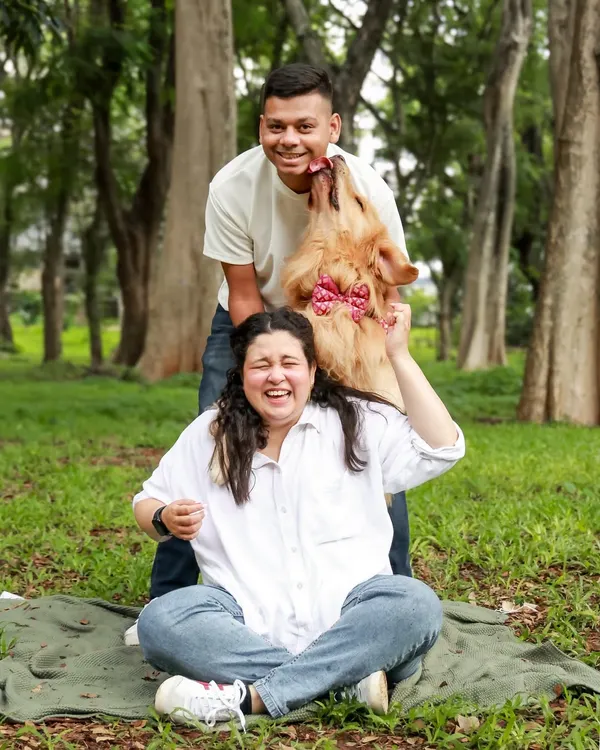 This is the kind of happy chaos I live for! A goofy, spontaneous lick from a fluffy Golden Retriever makes for the most memorable and authentic family photo.