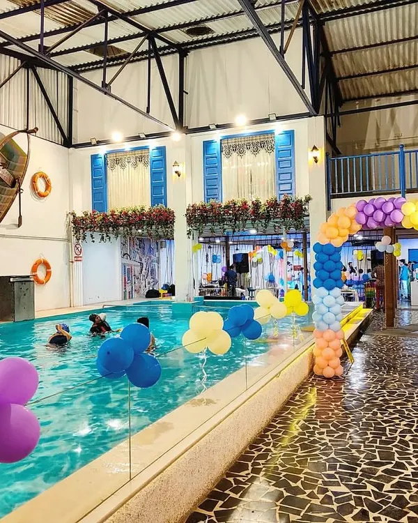 Our space transforms beautifully for any celebration. This shot shows a birthday party setup with colorful balloons and a festive atmosphere by the pool.