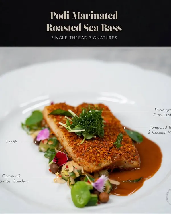 This is my Podi Marinated Roasted Sea Bass. The fish is crusted with a flavorful podi spice mix and served on a bed of coconut and cucumber banchan with a tempered tamarind and coconut milk nage.