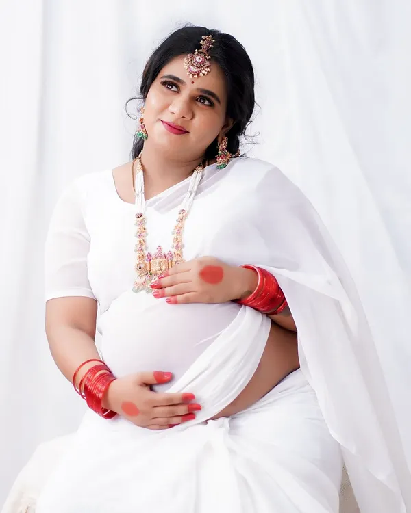 A serene and angelic look for a maternity photoshoot. I used soft, natural makeup to enhance her glow, paired with a white saree and traditional jewelry for a touch of elegance.