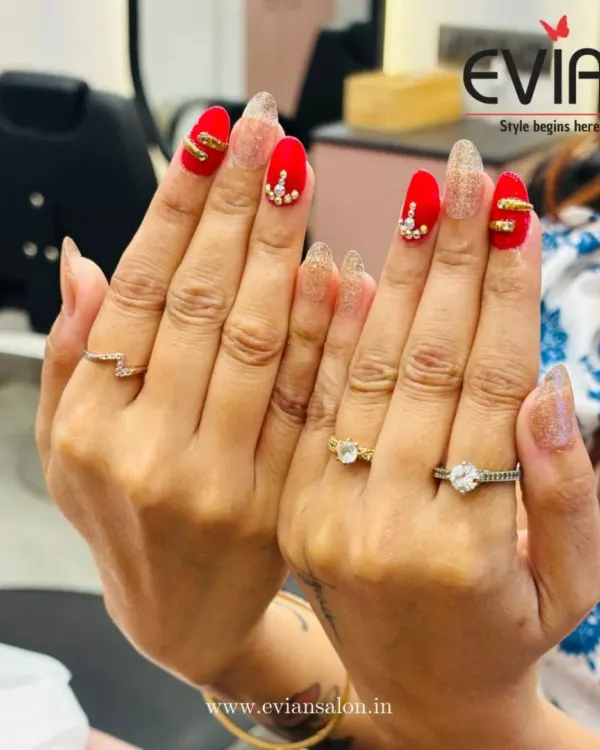 This is one of my favorite creations, perfect for a wedding or a big celebration. I combined a bold matte red with sparkling gold glitter extensions, adding hand-placed rhinestones and 3D gold bands for a truly luxurious look.