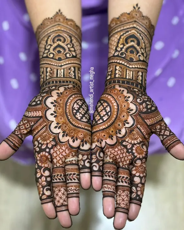 A classic full-hand bridal design featuring architectural dome motifs on the wrists and a beautiful central mandala on the palm. The fingers are detailed with complementary patterns for a complete look.