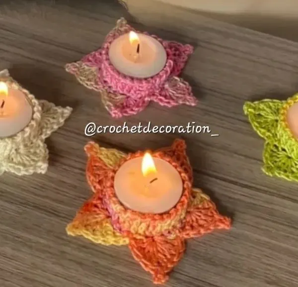 Our star-shaped crochet tea light holders, shown here in various colors with lit candles. They create a warm, festive glow and are perfect for celebrations like Diwali.