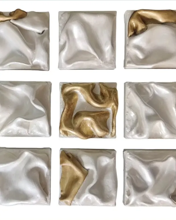 This is "THE DANCING SQUAD," a set of nine panels that create an abstract ballet of texture and color. The gold pieces are the lead performers, breaking the silver rhythm with energetic bursts, telling a story of harmony and contrast.