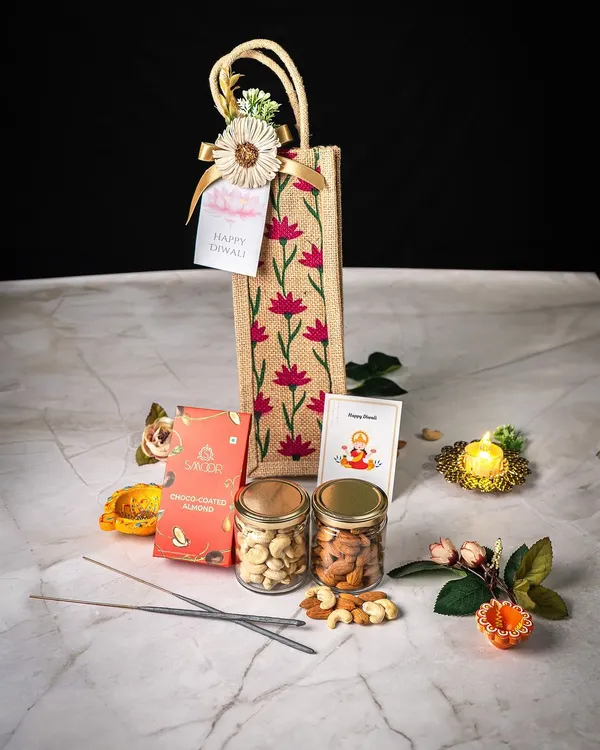 This elegant Diwali hamper is one of our signature festive offerings. It features a custom-printed jute bag containing premium assorted dry fruits in glass jars, artisanal chocolates, and traditional items like a decorative diya and incense sticks. We design these to be a complete, thoughtful gift for the festival of lights.