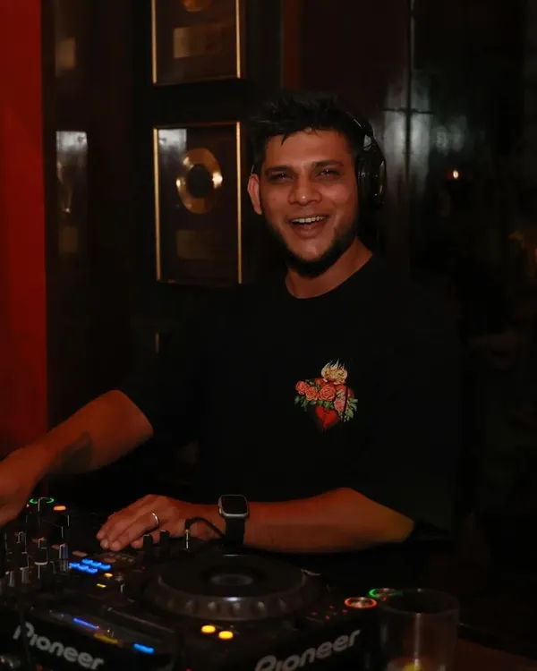 A simple photo of me doing what I love most. That smile is genuine, captured mid-set while I'm fully connected to the music and the crowd.