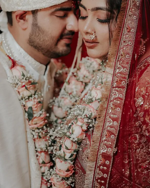 An intimate moment right after the Jaimala ceremony, where the world fades away. I focused on their serene expressions and the beautiful floral garlands that bind them, capturing the quiet beginning of their forever.