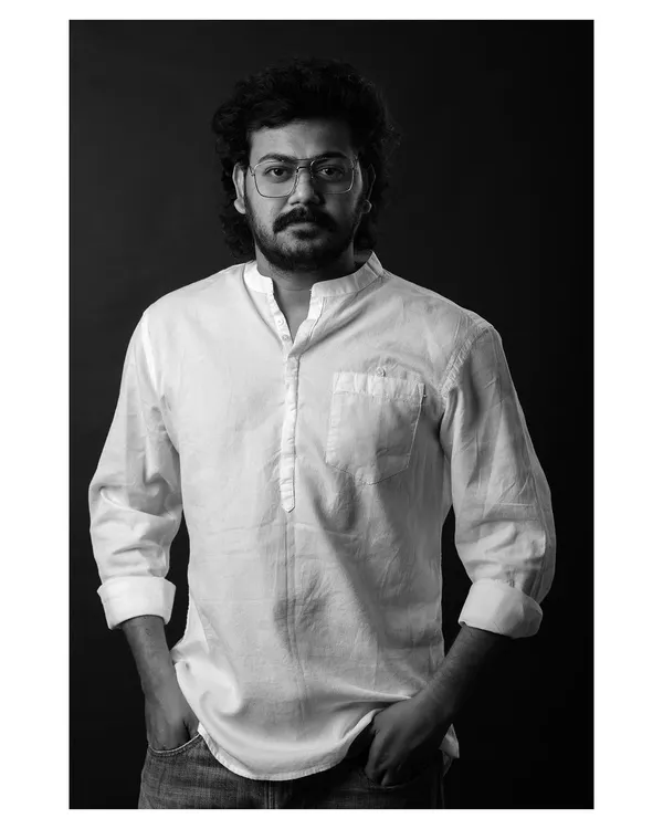 A classic black and white headshot for an actor. The direct gaze and simple lighting create a strong, confident portrait that lets his personality shine through.
